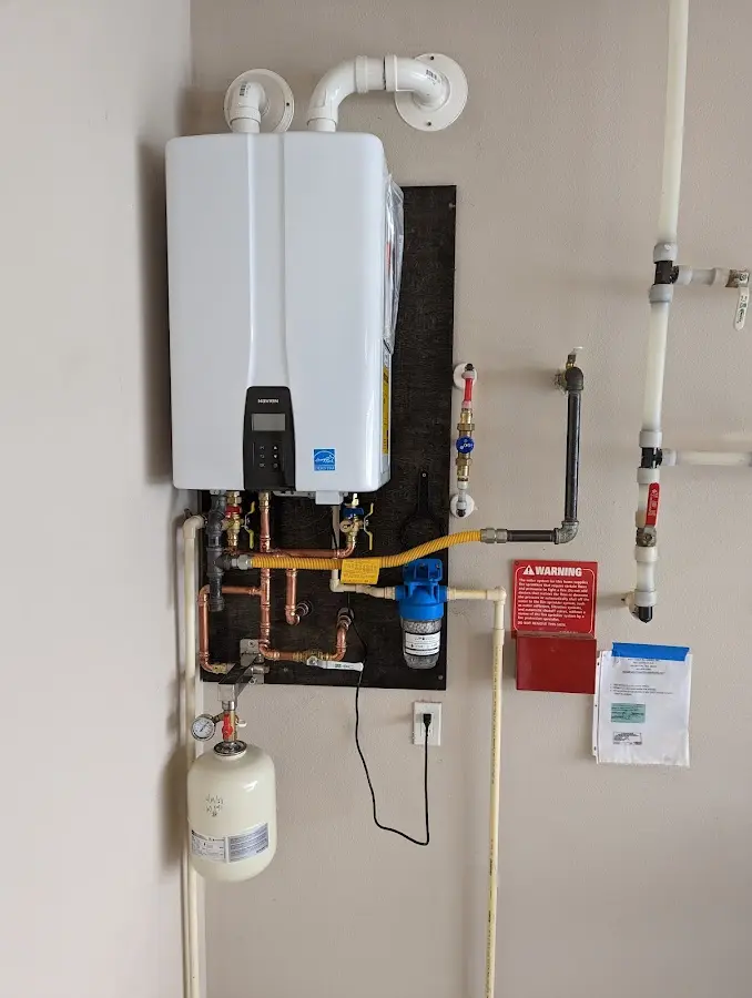Professional plumber installing copper piping in a Hadley home